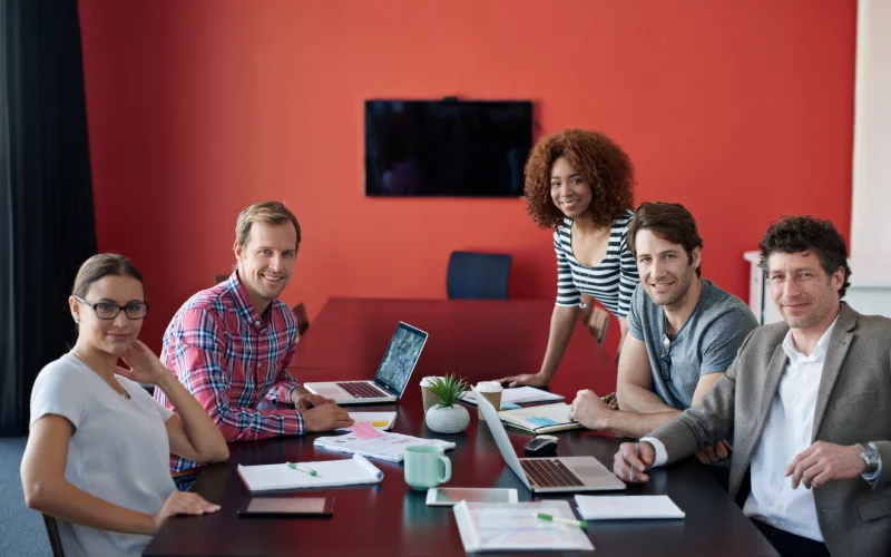 Group of people gathered in an office environment.