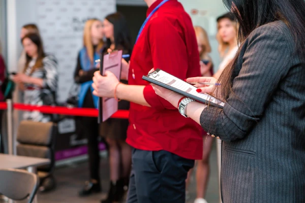 Professional woman writing on a tablet, representing smart technology and digital innovation.