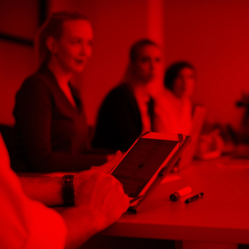 Business professional engaging in a meeting with a tablet, representing smart technology and innovation.
